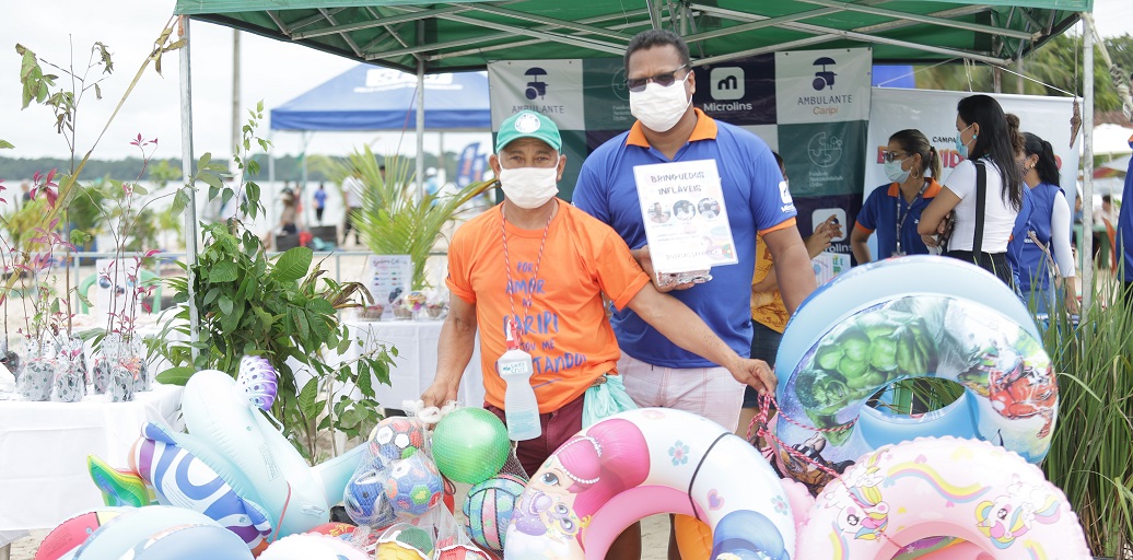 a group of people wearing masks and standing next to a large balloon