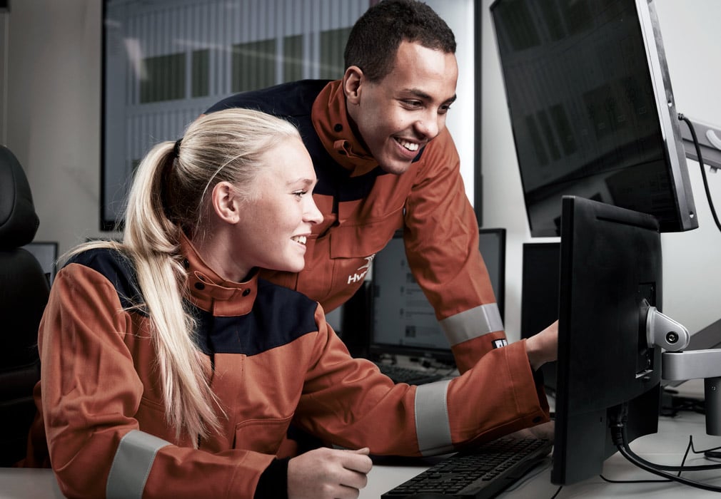 a man and a woman looking at a computer screen