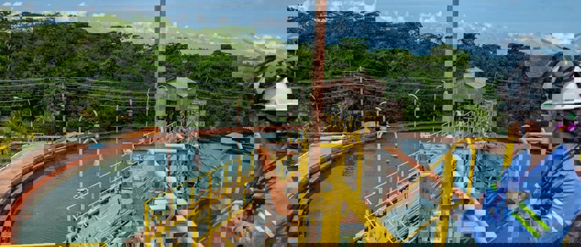 a person wearing a helmet and riding a boat on a river