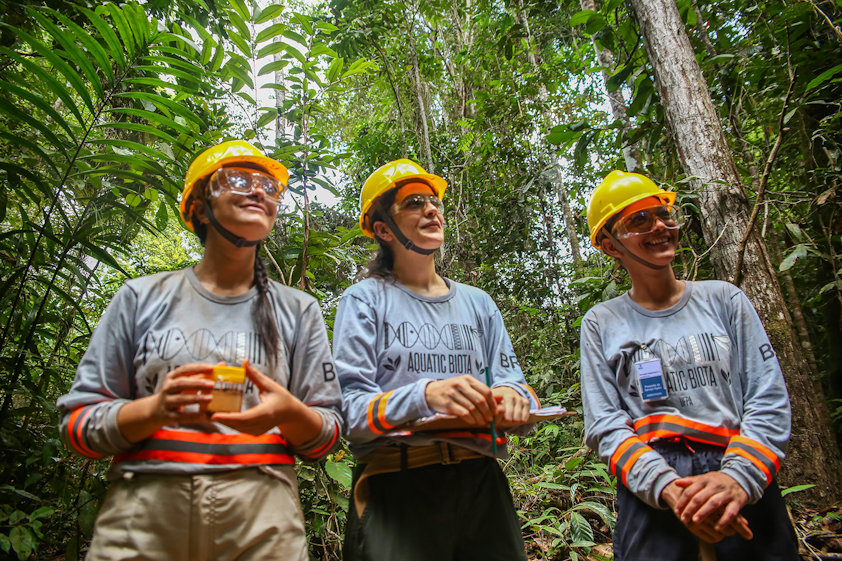 a group of people standing in the woods