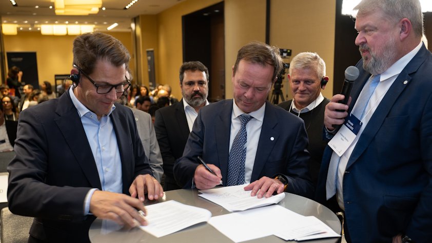 a group of men looking at papers