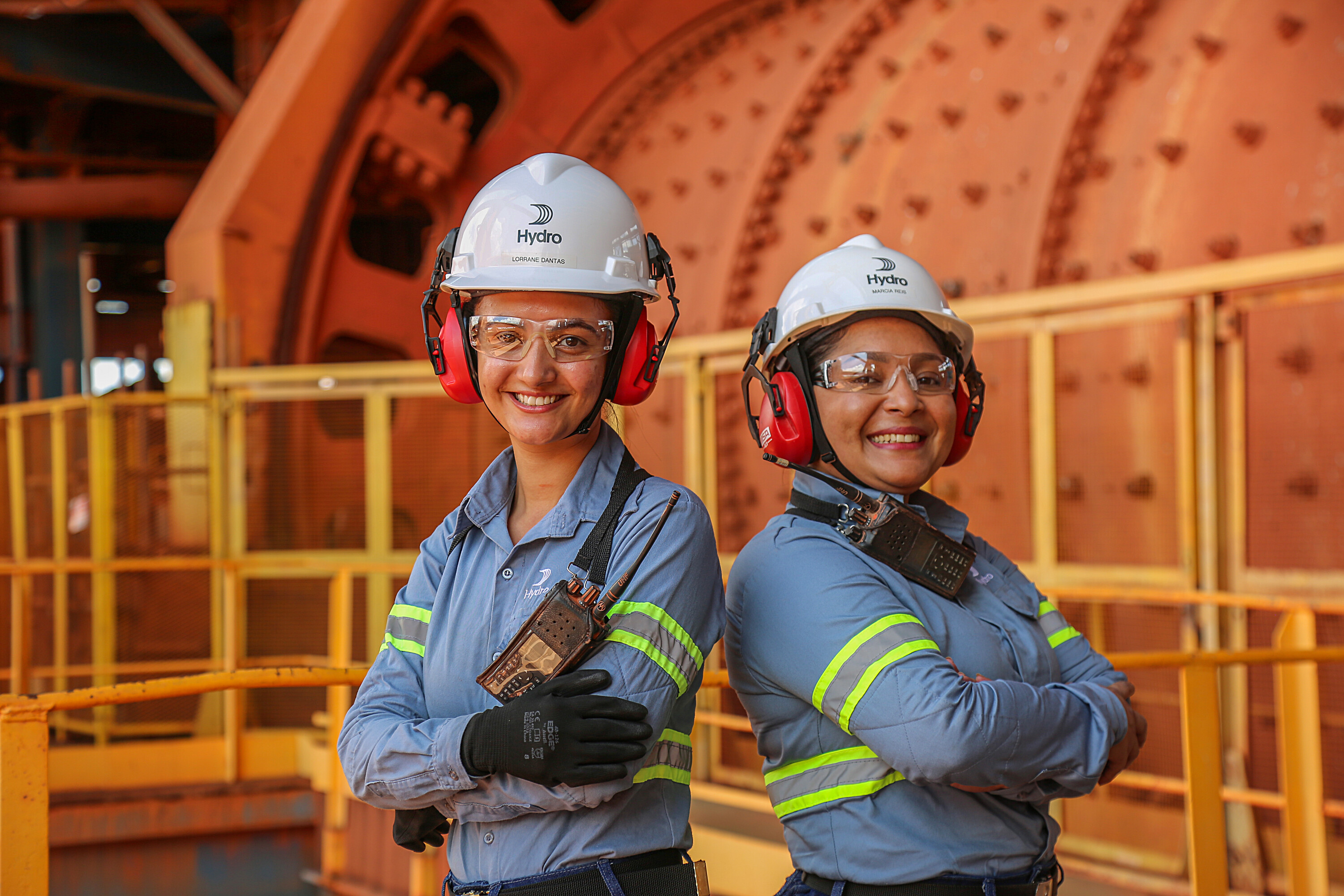 two women wearing hard hats and goggles