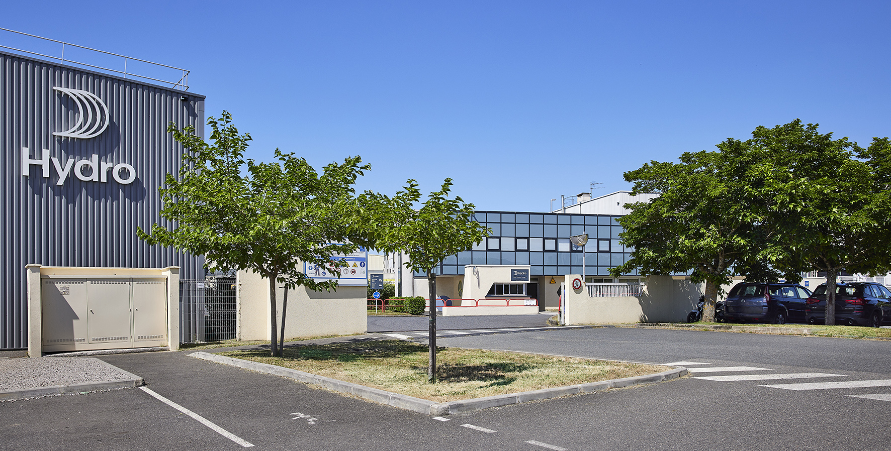 a building with trees and cars in front of it