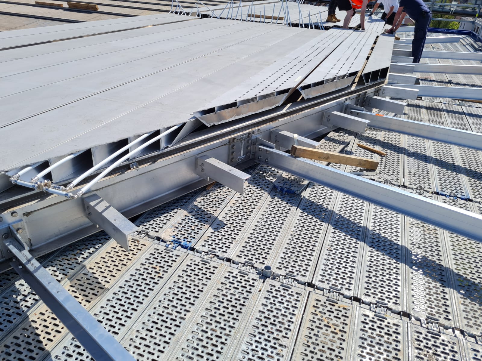 a group of people standing next to a metal platform